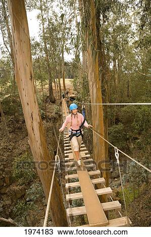 Hawaii, Maui, Zipline Adventure, Woman Walking Across A Wooden Bridge. View Large Photo Image Stock Image - Hawaii, Maui, Zipline Adventure, Woman Walking Across A Wooden Bridge.. Fotosearch