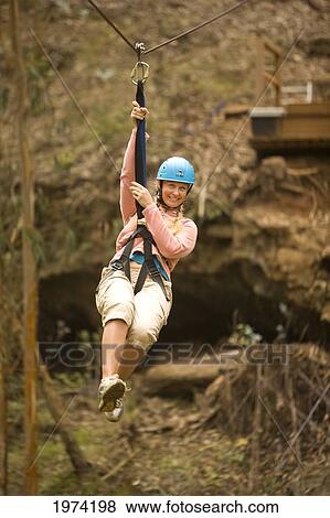 Hawaii, Maui, Zipline Adventure, Woman Riding The Zipline. View Large Photo Image Stock Photo - Hawaii, Maui, Zipline Adventure, Woman Riding The Zipline.. Fotosearch