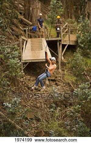 Stock Photo - Hawaii, Maui, Zipline Adventure, Woman Riding The Zipline.. Fotosearch