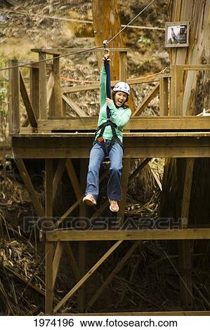 Stock Photograph - Hawaii, Maui, Zipline Adventure, Woman Riding The Zipline.. Fotosearch