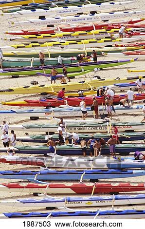 Stock Image - Hawaii, Molokai, Hale O Lono Harbor, Overhead View Of Outrigger Canoes Lined Up On Beach Before Molokai Channel Race. No Model Release. Fotosearch