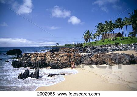 Hawaii, Molokai, Kaluako'i Beach, Woman Sits Along Shoreline, Rock Wall Background View Large Photo Image Stock Photography - Hawaii, Molokai, Kaluako'i Beach, Woman Sits Along Shoreline, Rock Wall Background. Fotosearch