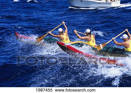 Stock Photography - Hawaii, Molokai To Oahu, Kaiwi Channel, Women Paddlers In Na Wahine O Kekai Race, Escort Boat In Background. No Model Release. Fotosearch