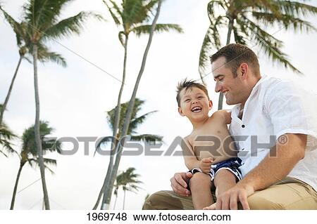 Stock Photo - Hawaii, Oahu, A Happy Father Interacting With His Son.. Fotosearch