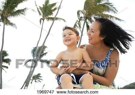 Stock Photo - Hawaii, Oahu, A Happy Mother Interacting With Her Son.. Fotosearch