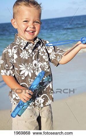 Hawaii, Oahu, Adorable Little Boy With An Aloha Shirt Playing With Bubbles. View Large Photo Image Stock Photo - Hawaii, Oahu, Adorable Little Boy With An Aloha Shirt Playing With Bubbles.. Fotosearch