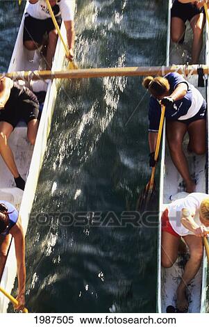 Stock Photography - Hawaii, Oahu, Ala Wai Channel, Overhead View Of Double Hull Canoe, Women's Paddling. No Model Release. Fotosearch
