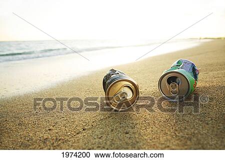 Stock Image - Hawaii, Oahu, Aluminum Cans On The Beach.. Fotosearch