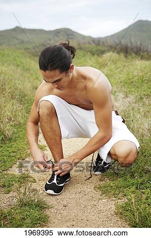 Hawaii, Oahu, Atheltic Male Tying His Shoelace On A Jogging Path. View Large Photo Image Stock Photography - Hawaii, Oahu, Atheltic Male Tying His Shoelace On A Jogging Path.. Fotosearch