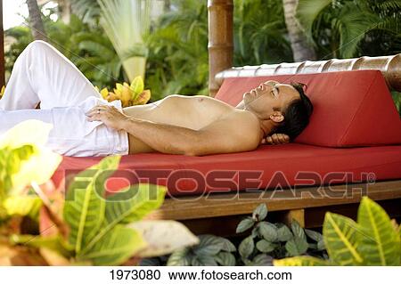 Hawaii, Oahu, Attractive Man Resting On An Outdoor Bed. View Large Photo Image Stock Image - Hawaii, Oahu, Attractive Man Resting On An Outdoor Bed.. Fotosearch