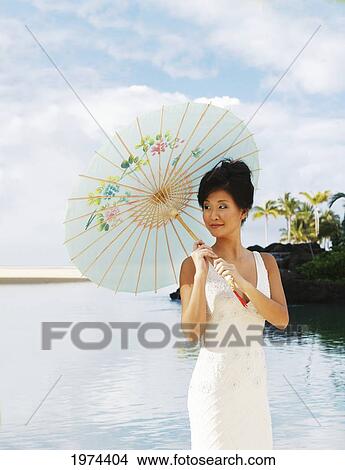Picture - Hawaii, Oahu, Attractive Young Asian Woman On The Beach.. Fotosearch