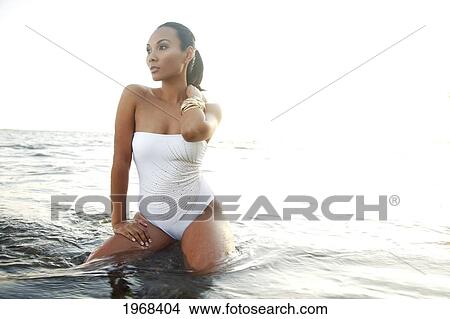 Picture - Hawaii, Oahu, Attractive Young Woman On The Shoreline With Gold Bracelets.. Fotosearch