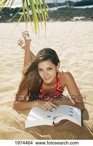 Hawaii, Oahu, Attractive Young Woman On The Beach Reading A Book. View Large Photo Image Picture - Hawaii, Oahu, Attractive Young Woman On The Beach Reading A Book.. Fotosearch