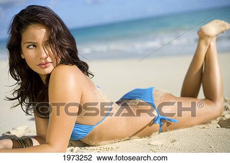 Stock Image - Hawaii, Oahu, Attractive Young Woman On The Beach.. Fotosearch