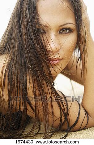 Stock Image - Hawaii, Oahu, Attractive Young Woman On The Beach.. Fotosearch
