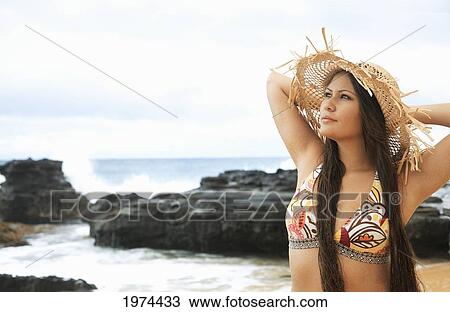 Stock Image - Hawaii, Oahu, Attractive Young Woman On The Beach.. Fotosearch