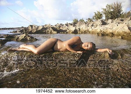 Stock Image - Hawaii, Oahu, Attractive Young Woman On The Beach.. Fotosearch
