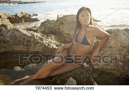 Stock Image - Hawaii, Oahu, Attractive Young Woman On The Beach.. Fotosearch