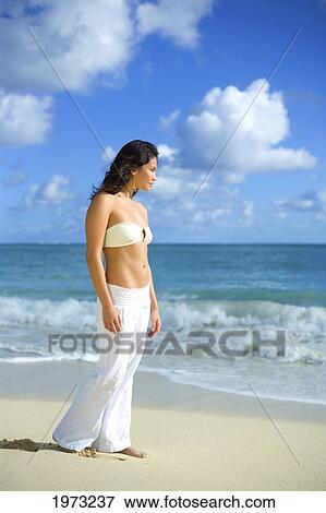 Stock Photo - Hawaii, Oahu, Attractive Young Woman On The Beach.. Fotosearch