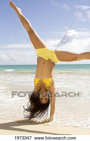 Hawaii, Oahu, Attractive Young Woman On The Beach Having Fun. View Large Photo Image Stock Photo - Hawaii, Oahu, Attractive Young Woman On The Beach Having Fun.. Fotosearch