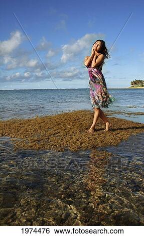 Stock Photograph - Hawaii, Oahu, Attractive Young Woman On The Beach.. Fotosearch