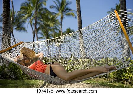 Stock Photography - Hawaii, Oahu, Attractive Young Woman Laying In A Hammock.. Fotosearch