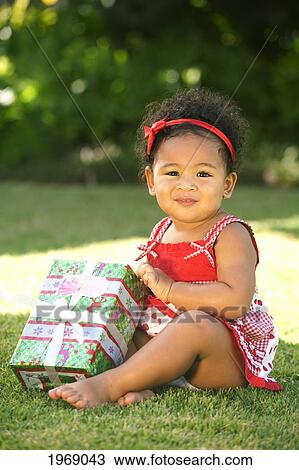 Hawaii, Oahu, Baby Girl Holding A Christmas Present. View Large Photo Image Stock Image - Hawaii, Oahu, Baby Girl Holding A Christmas Present.. Fotosearch