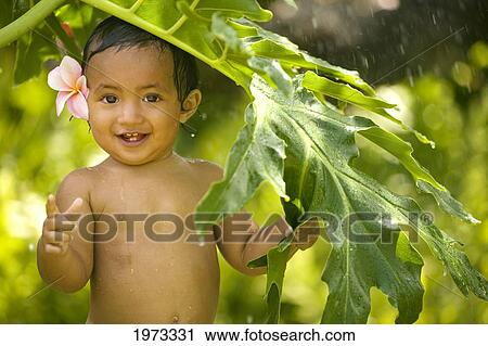 Stock Image - Hawaii, Oahu, Baby Girl Playing With Water.. Fotosearch