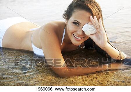 Hawaii, Oahu, Beautiful Female Holding A Coral Shell Over One Eye In The Water View Large Photo Image Stock Photograph - Hawaii, Oahu, Beautiful Female Holding A Coral Shell Over One Eye In The Water. Fotosearch