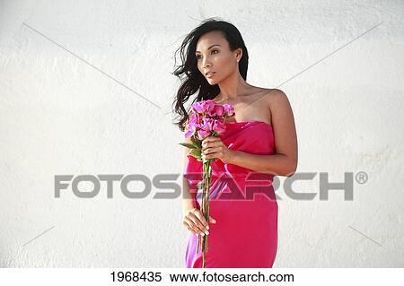 Hawaii, Oahu, Beautiful Female Holding Pink Roses In An Elegant Pink Dress. View Large Photo Image Stock Photography - Hawaii, Oahu, Beautiful Female Holding Pink Roses In An Elegant Pink Dress.. Fotosearch