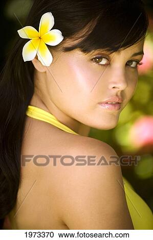 Hawaii, Oahu, Beautiful Headshot Of A Young Girl With A Plumeria In Her Ear. View Large Photo Image Stock Image - Hawaii, Oahu, Beautiful Headshot Of A Young Girl With A Plumeria In Her Ear.. Fotosearch