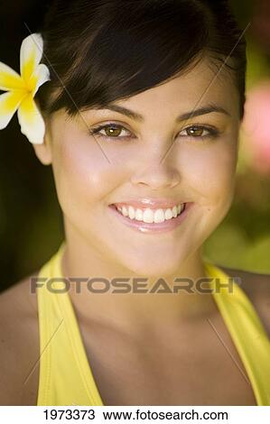 Hawaii, Oahu, Beautiful Headshot Of A Young Girl With A Plumeria In Her Ear. View Large Photo Image Stock Image - Hawaii, Oahu, Beautiful Headshot Of A Young Girl With A Plumeria In Her Ear.. Fotosearch
