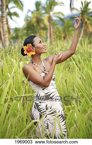 Hawaii, Oahu, Beautiful Local Female Doing A Hula Dance In A Coconut Field With Tall Green Grass. View Large Photo Image Stock Image - Hawaii, Oahu, Beautiful Local Female Doing A Hula Dance In A Coconut Field With Tall Green Grass.. Fotosearch