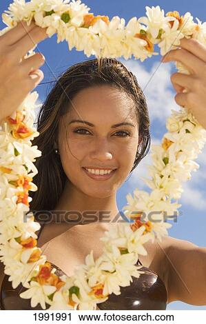 Hawaii, Oahu, Beautiful Local Girl Holding Out A Yellow Lei, View Through Lei. View Large Photo Image Stock Image - Hawaii, Oahu, Beautiful Local Girl Holding Out A Yellow Lei, View Through Lei.. Fotosearch