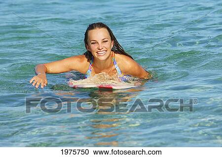Stock Image - Hawaii, Oahu, Beautiful Surfer Girl In The Ocean.. Fotosearch