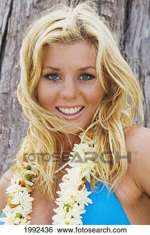 Hawaii, Oahu, Beautiful Young Woman Wearing A Lei Leaning Against A Tree, Close-Up. View Large Photo Image Stock Photograph - Hawaii, Oahu, Beautiful Young Woman Wearing A Lei Leaning Against A Tree, Close-Up.. Fotosearch