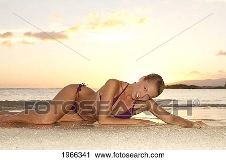 Hawaii, Oahu, Blond Woman Lounging On Beach, Sunset Light. View Large Photo Image Stock Image - Hawaii, Oahu, Blond Woman Lounging On Beach, Sunset Light.. Fotosearch