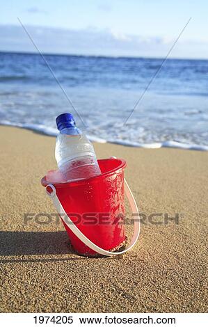 Hawaii, Oahu, Bottle Of Water In A Red Bucket On The Beach. View Large Photo Image Stock Photography - Hawaii, Oahu, Bottle Of Water In A Red Bucket On The Beach.. Fotosearch
