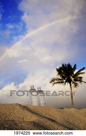 Stock Photography - Hawaii, Oahu, Bottle Of Water On The Beach.. Fotosearch