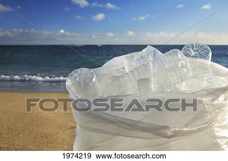Stock Photo - Hawaii, Oahu, Bottles Of Water In A Trash Bag On The Beach.. Fotosearch