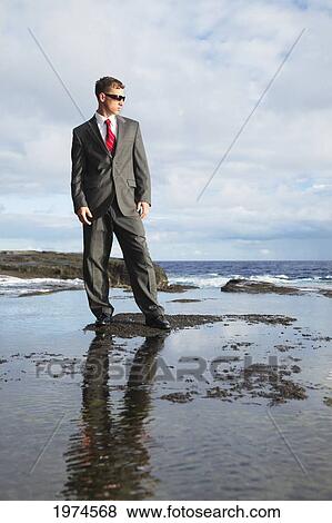 Hawaii, Oahu, Business Man In His Suit At Rocky Coastline. View Large Photo Image Stock Photo - Hawaii, Oahu, Business Man In His Suit At Rocky Coastline.. Fotosearch