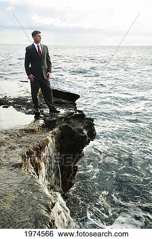 Stock Photograph - Hawaii, Oahu, Business Man In His Suit At Rocky Coastline.. Fotosearch