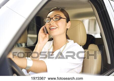 Hawaii, Oahu, Business Woman On The Phone In Her Car. View Large Photo Image Stock Photo - Hawaii, Oahu, Business Woman On The Phone In Her Car.. Fotosearch