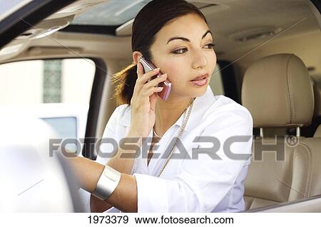Stock Photo - Hawaii, Oahu, Business Woman On The Phone In Her Car.. Fotosearch