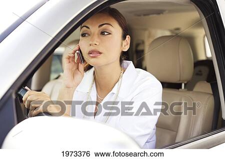 Hawaii, Oahu, Business Woman On The Phone In Her Car. View Large Photo Image Stock Photograph - Hawaii, Oahu, Business Woman On The Phone In Her Car.. Fotosearch