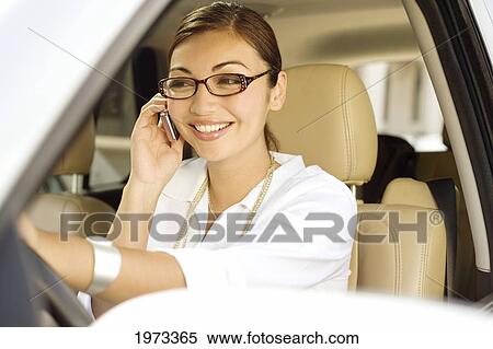 Stock Photography - Hawaii, Oahu, Business Woman On The Phone In Her Car.. Fotosearch