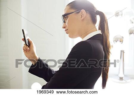 Stock Photo - Hawaii, Oahu, Business Woman With Her Cell Phone.. Fotosearch