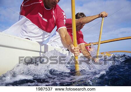 Hawaii, Oahu, Close-Up Angle Of Men Paddling Outrigger Canoe As Blade Goes Into Water. No Model Release View Large Photo Image Stock Photo - Hawaii, Oahu, Close-Up Angle Of Men Paddling Outrigger Canoe As Blade Goes Into Water. No Model Release. Fotosearch