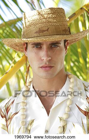 Hawaii, Oahu, Closeup Headshot Of European Male Wearing Aloha Shirt With White Kukui Nut Lei And Rafia Hat, Palm Frond In The Background. View Large Photo Image Picture - Hawaii, Oahu, Closeup Headshot Of European Male Wearing Aloha Shirt With White Kukui Nut Lei And Rafia Hat, Palm Frond In The Background.. Fotosearch