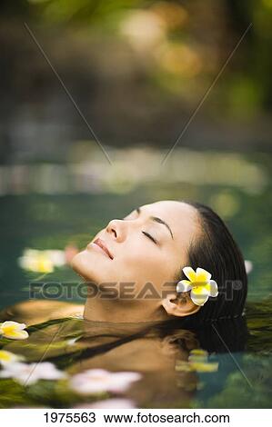 Stock Image - Hawaii, Oahu, Closeup Of Young Woman's Face Relaxing In Tropical Pool.. Fotosearch